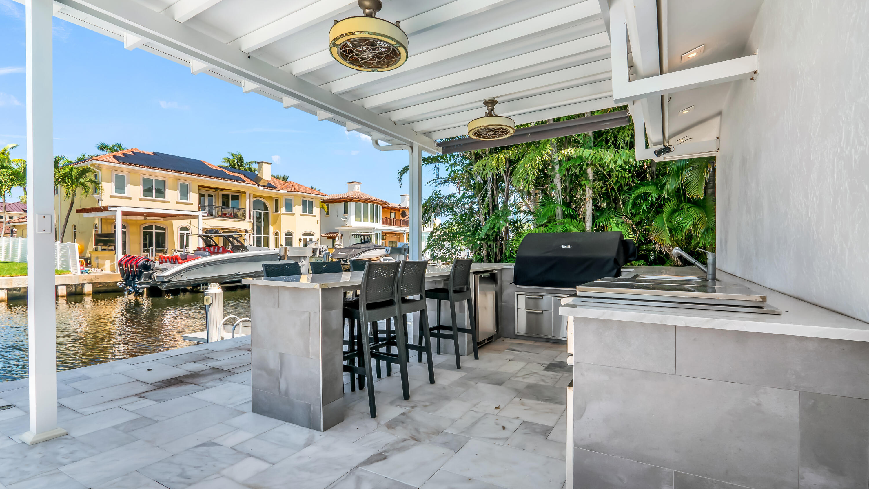 831 Dover Street Boca Raton, FL 33487 - Photo 46 of 54 a view of a patio with dining table and chairs with plants