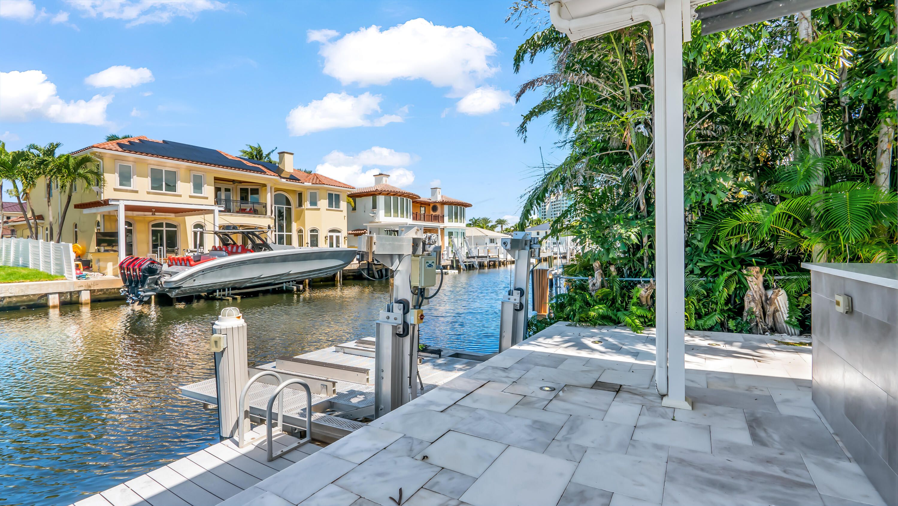 831 Dover Street Boca Raton, FL 33487 - Photo 47 of 54 a view of a lake with a house and a yard