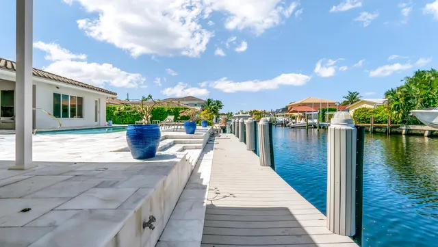 a view of a house with swimming pool and sitting area