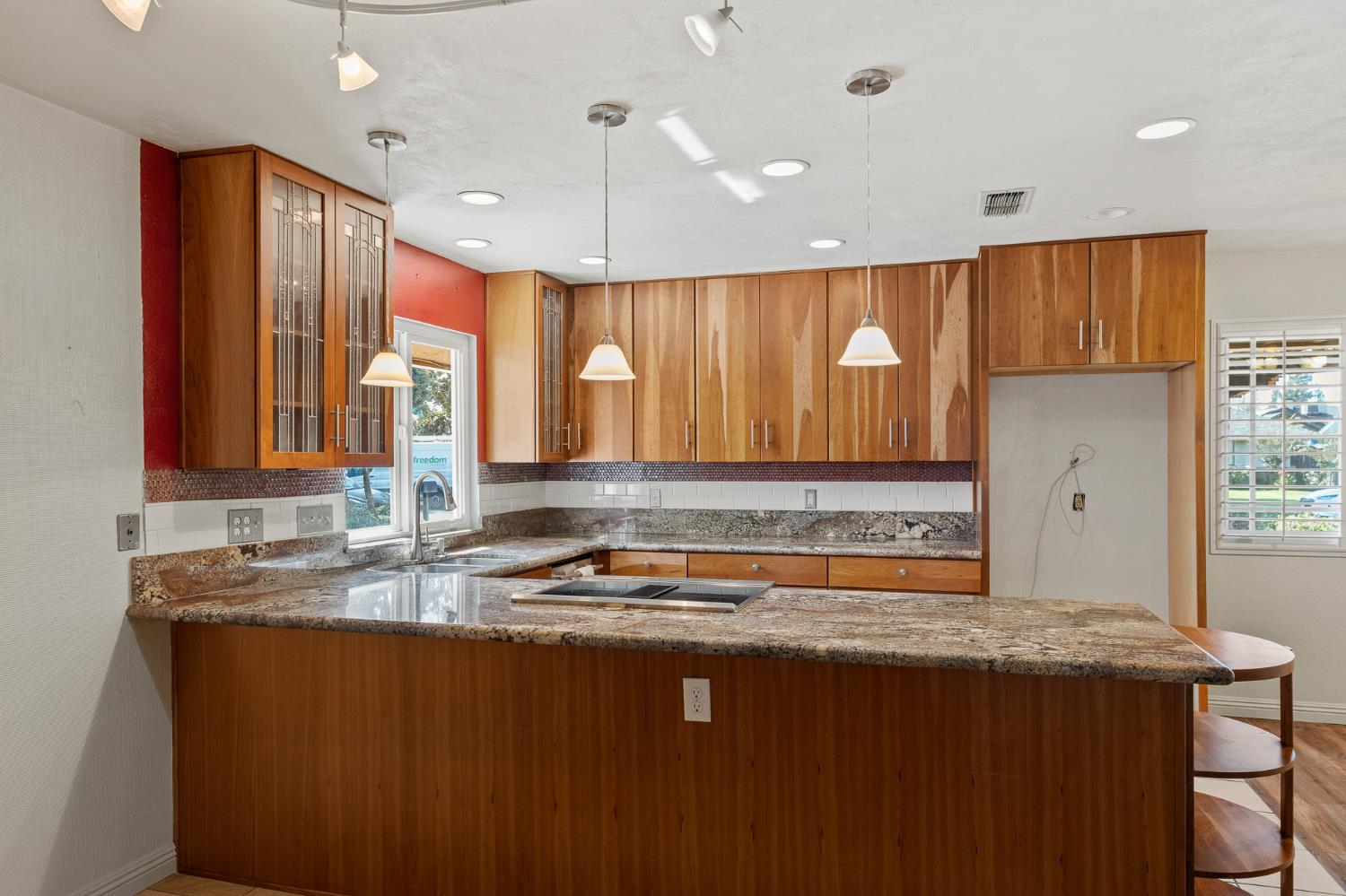 2179 Rall Avenue Clovis, CA 93611 - Photo 12 of 54 a kitchen with kitchen island granite countertop a sink a counter top space and cabinets