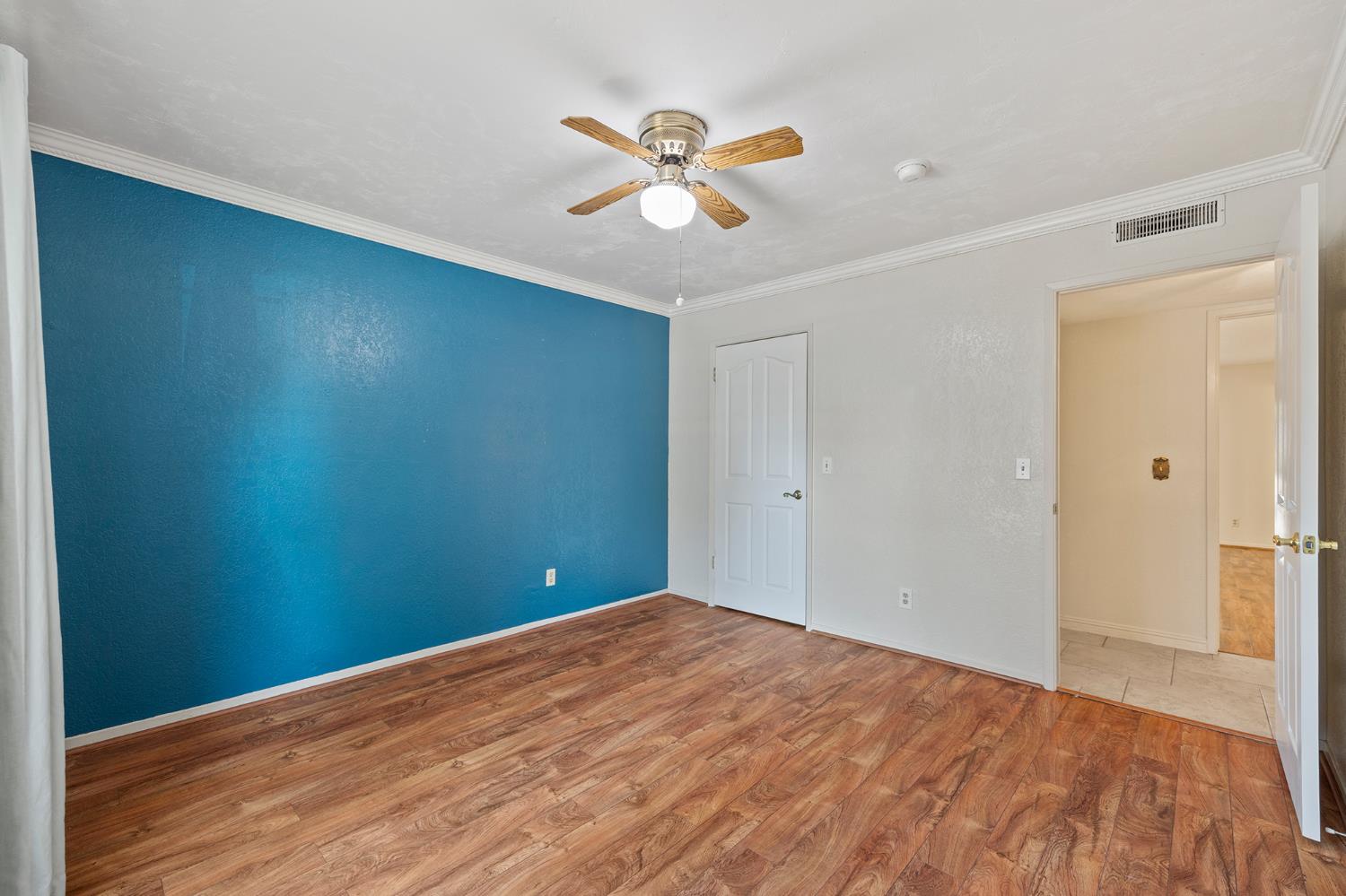 2179 Rall Avenue Clovis, CA 93611 - Photo 29 of 54 a view of a big room with wooden floor and a ceiling fan