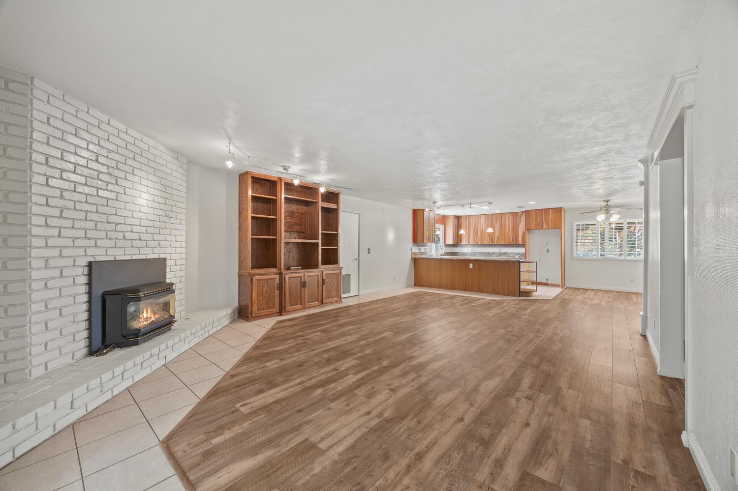 2179 Rall Avenue Clovis, CA 93611 - Photo 35 of 54 a view of empty room with a fireplace and wooden floor