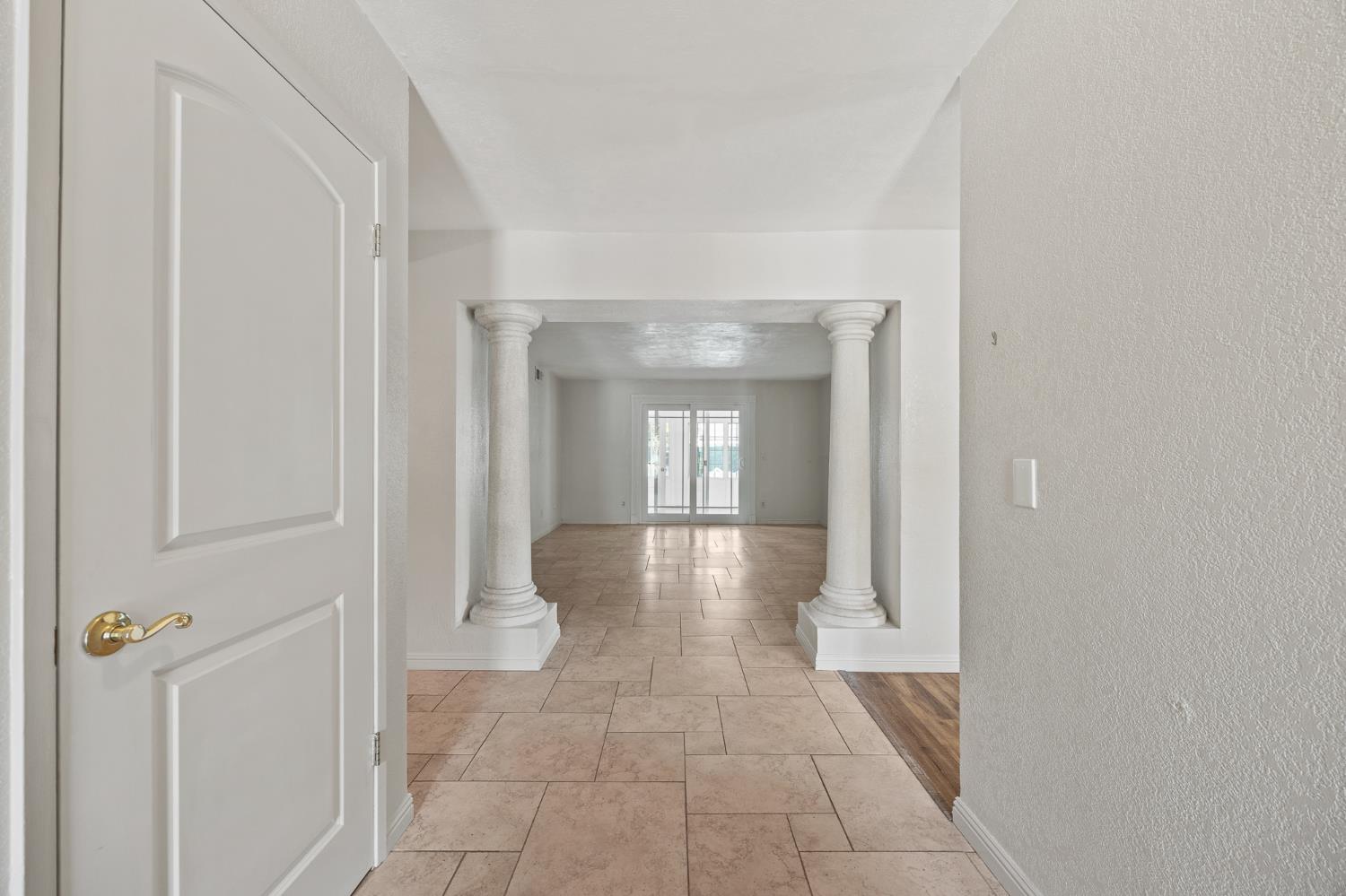 2179 Rall Avenue Clovis, CA 93611 - Photo 5 of 54 a view of a hallway with wooden floor and a bathroom