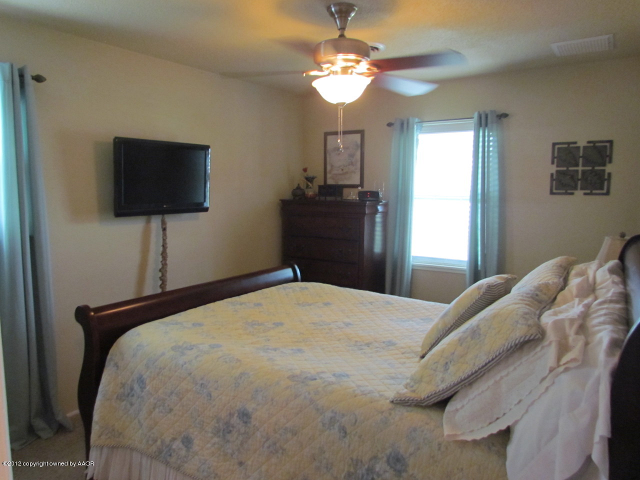 5313 Parker Street Amarillo, TX 79110 - Photo 17 of 26 a bedroom with a bed and a flat screen tv