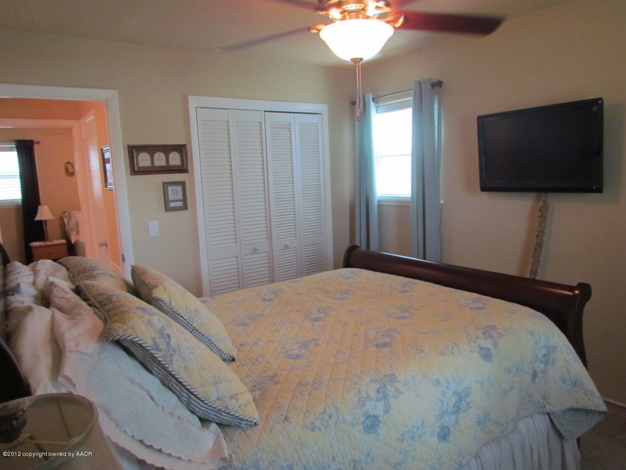 5313 Parker Street Amarillo, TX 79110 - Photo 18 of 26 a bedroom with a bed and a flat screen tv