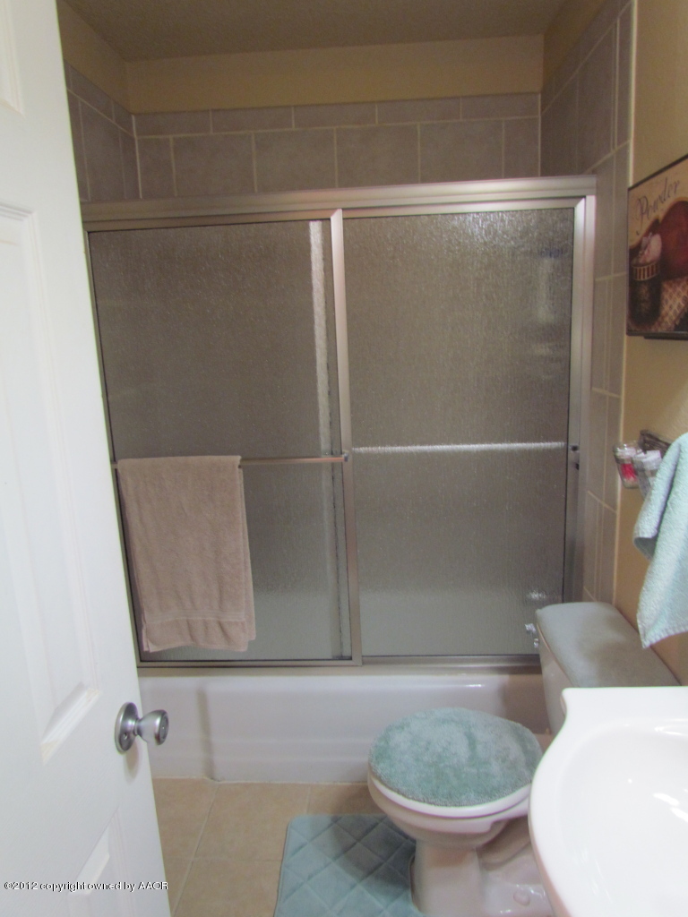 5313 Parker Street Amarillo, TX 79110 - Photo 20 of 26 a bathroom with a toilet and a sink