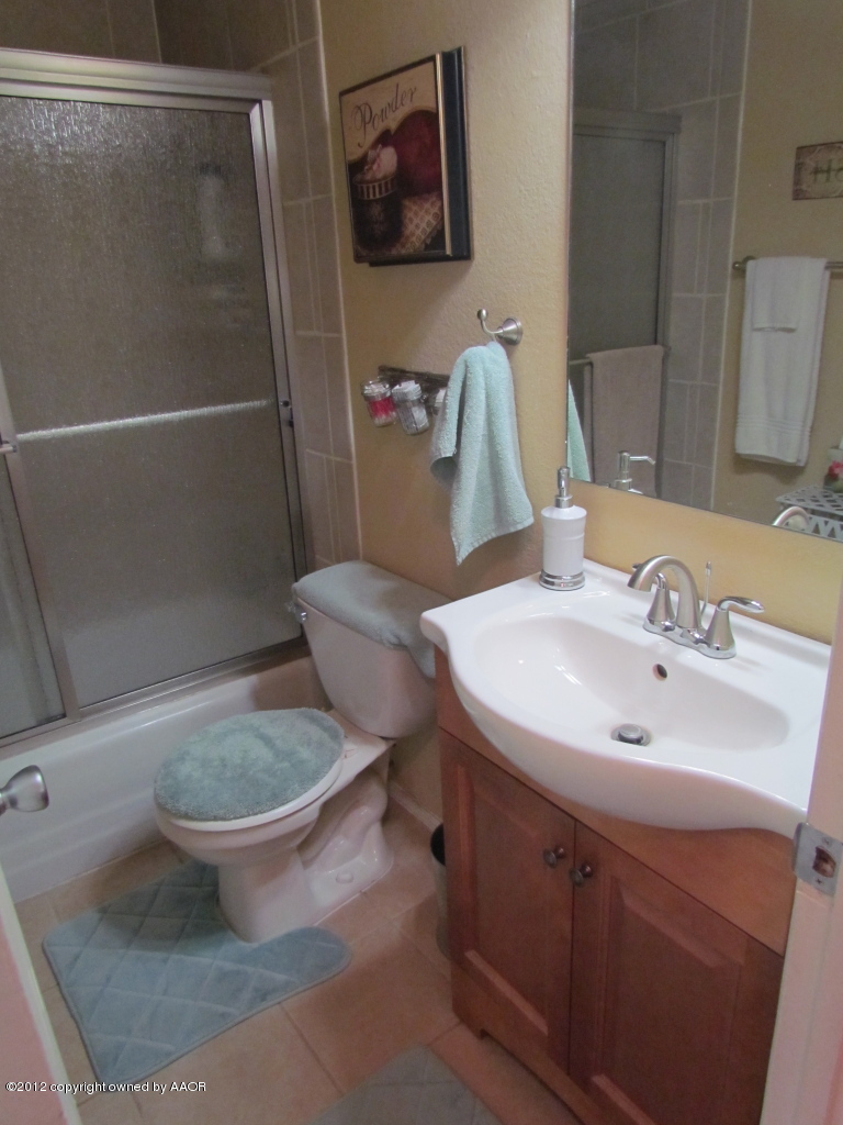 5313 Parker Street Amarillo, TX 79110 - Photo 21 of 26 a bathroom with a sink toilet and shower