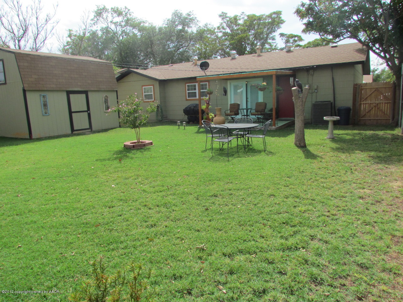 5313 Parker Street Amarillo, TX 79110 - Photo 23 of 26 a backyard of a house with table and chairs