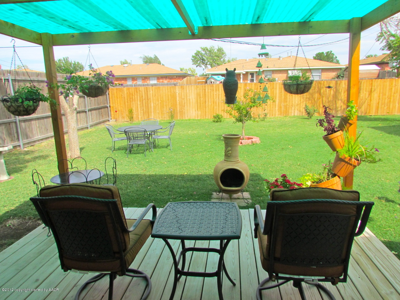 5313 Parker Street Amarillo, TX 79110 - Photo 26 of 26 a view of a backyard with table and chairs and potted plants
