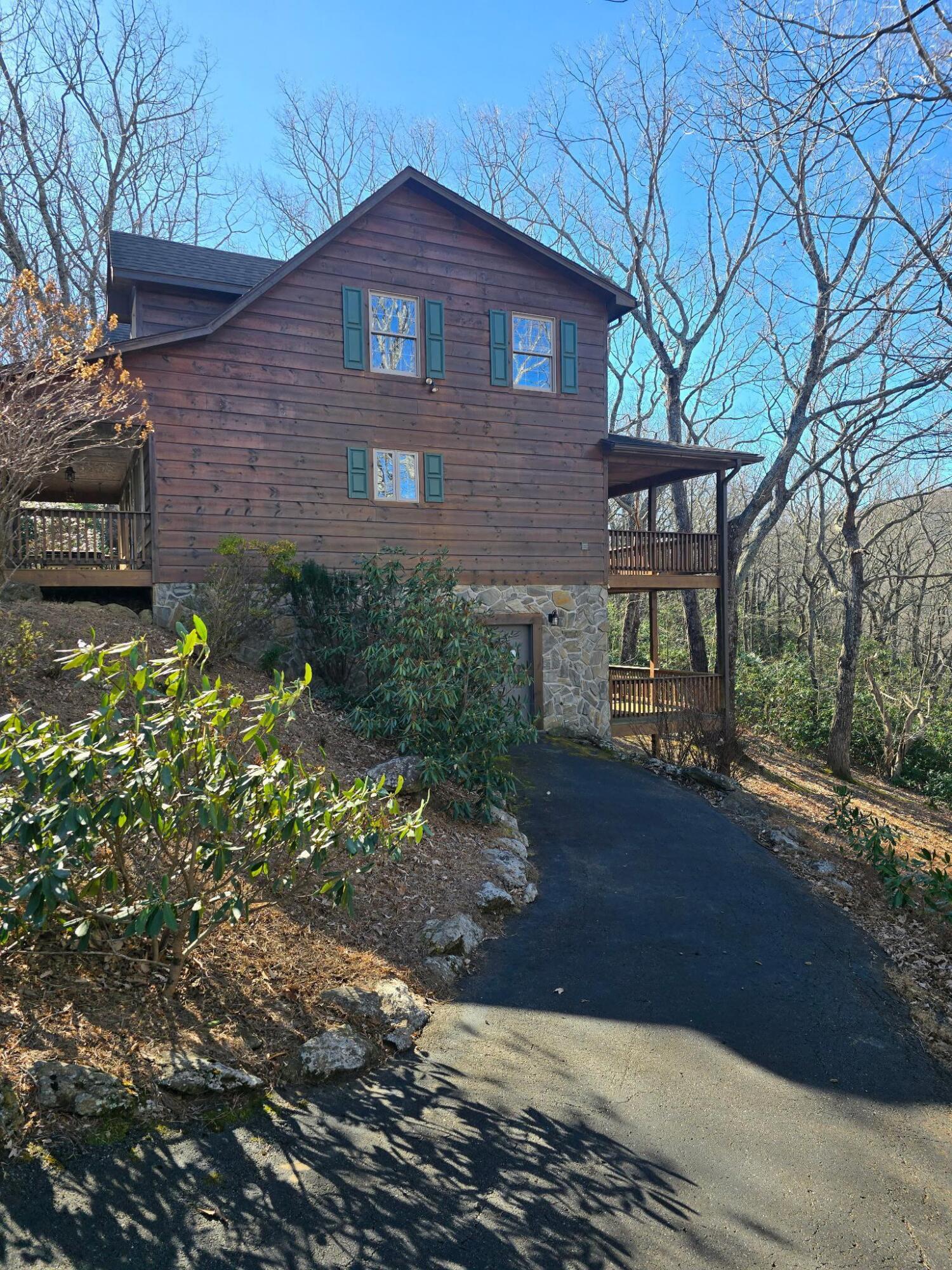 102 Flint Ridge Trail Fancy Gap, VA 24328 - Photo 11 of 26 a view of a brick house with a yard