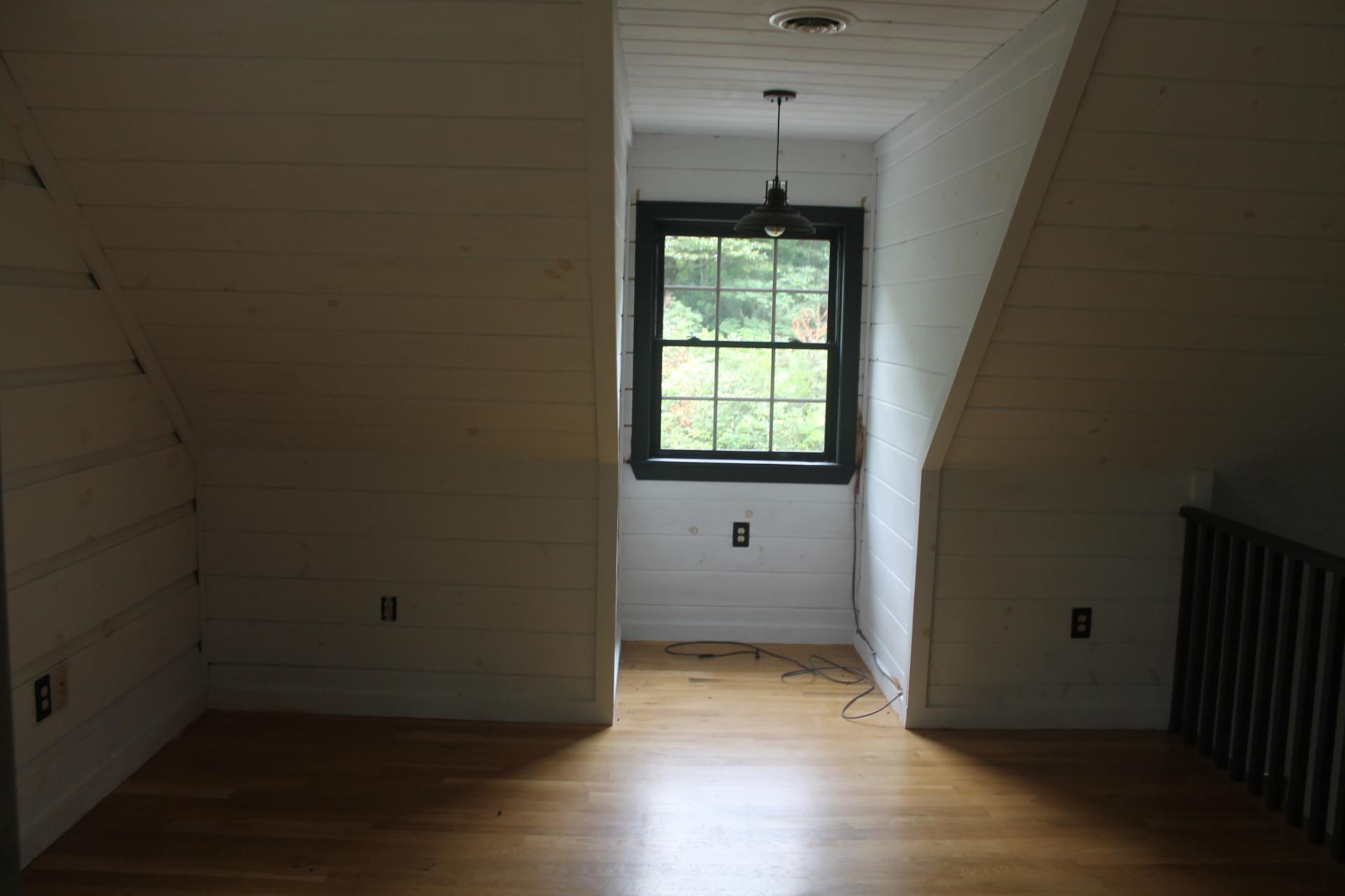 102 Flint Ridge Trail Fancy Gap, VA 24328 - Photo 17 of 26 an empty room with wooden floor and windows