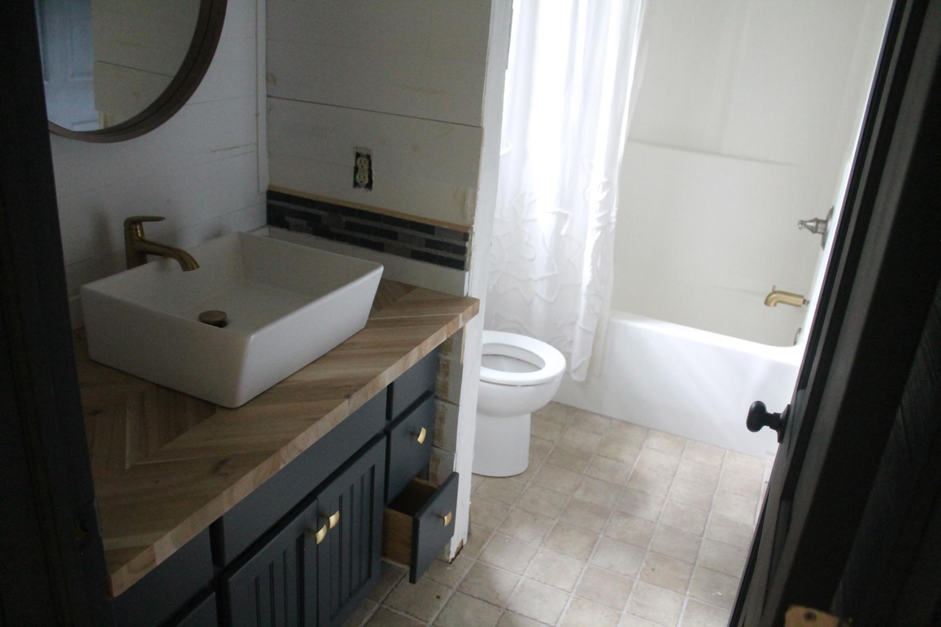 102 Flint Ridge Trail Fancy Gap, VA 24328 - Photo 21 of 26 a bathroom with a sink a toilet and shower