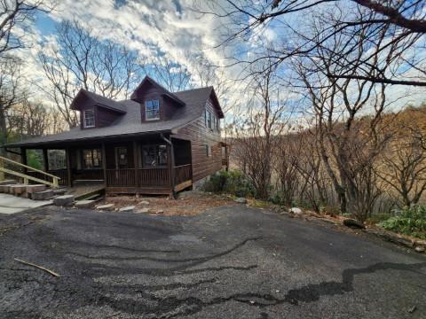102 Flint Ridge Trail Fancy Gap, VA 24328 - Photo 7 of 26 a view of a house with large windows and a tree