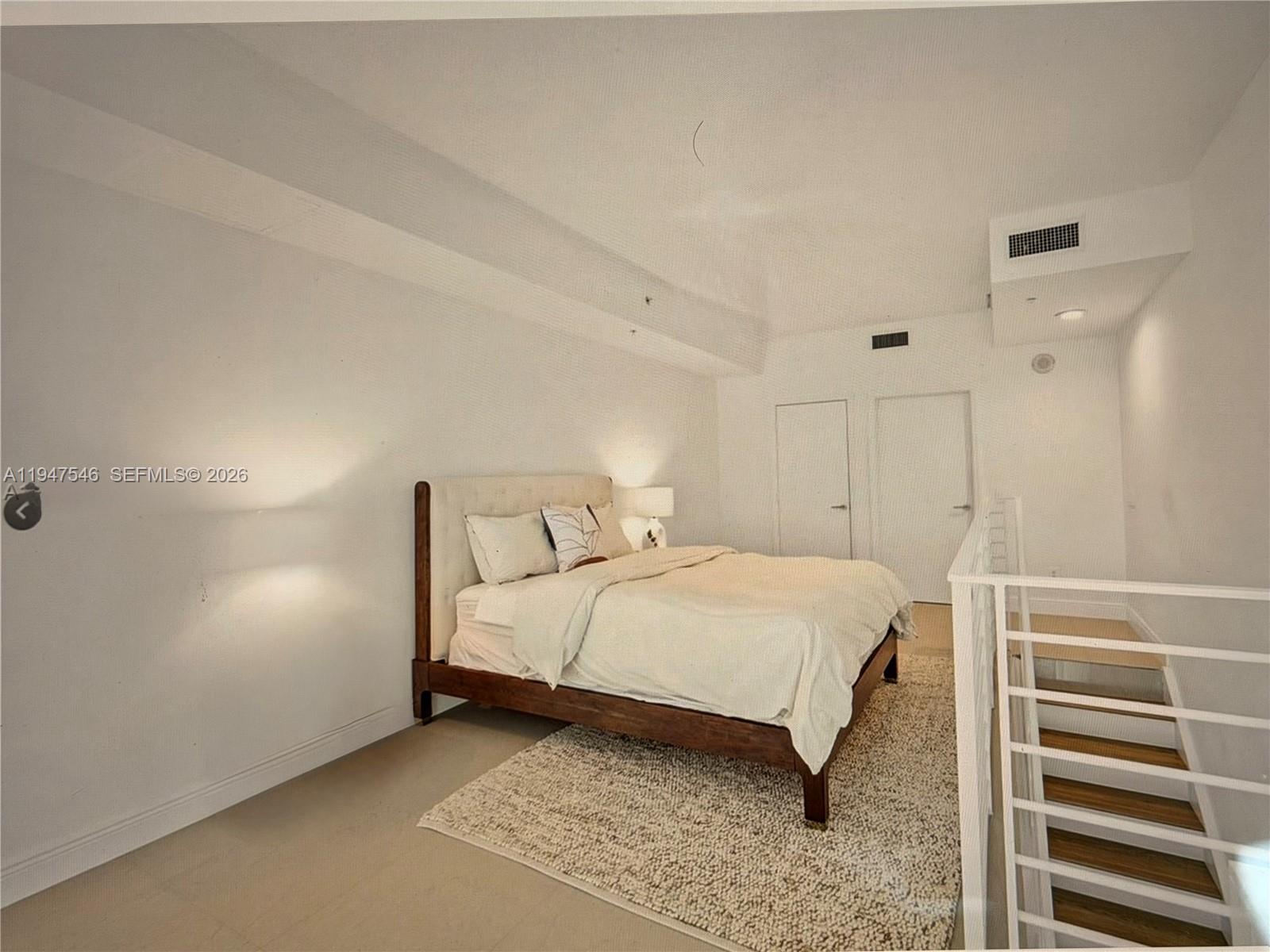 60 Southwest 13th Street, Unit 3214 Miami, FL 33130 - Photo 4 of 13 a bed room with a bed and a night stand