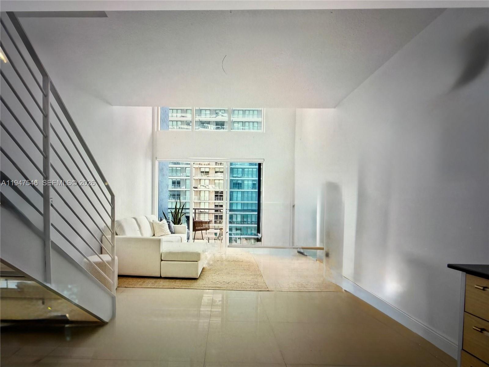 60 Southwest 13th Street, Unit 3214 Miami, FL 33130 - Photo 6 of 13 a spacious bedroom with a bed and a large window