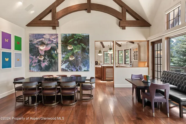 a view of a dining room with furniture wooden floor and chandelier