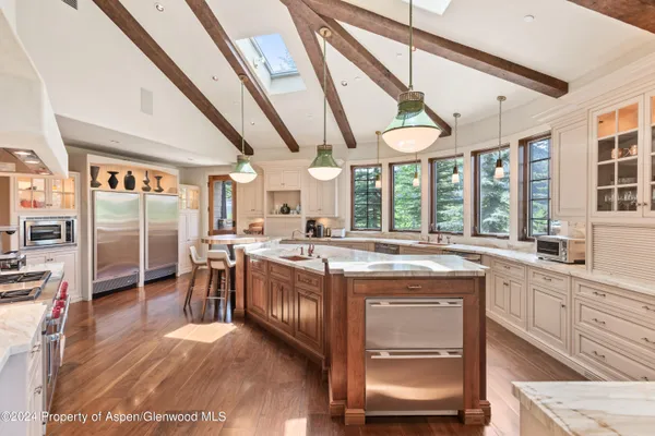 a kitchen with stainless steel appliances granite countertop a stove and cabinets