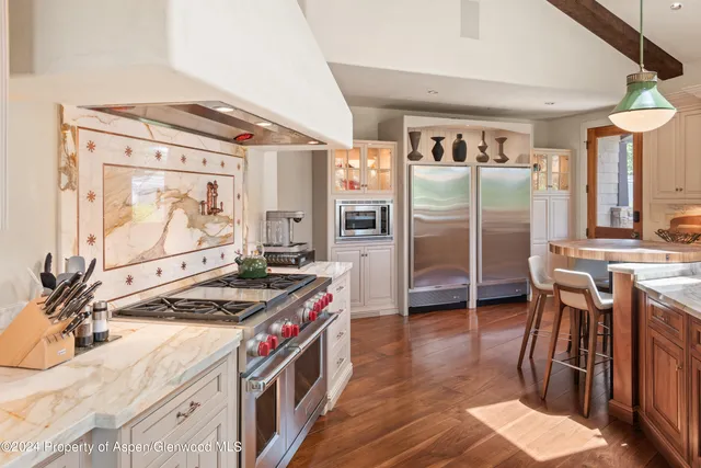 a kitchen with stainless steel appliances granite countertop a stove and a refrigerator