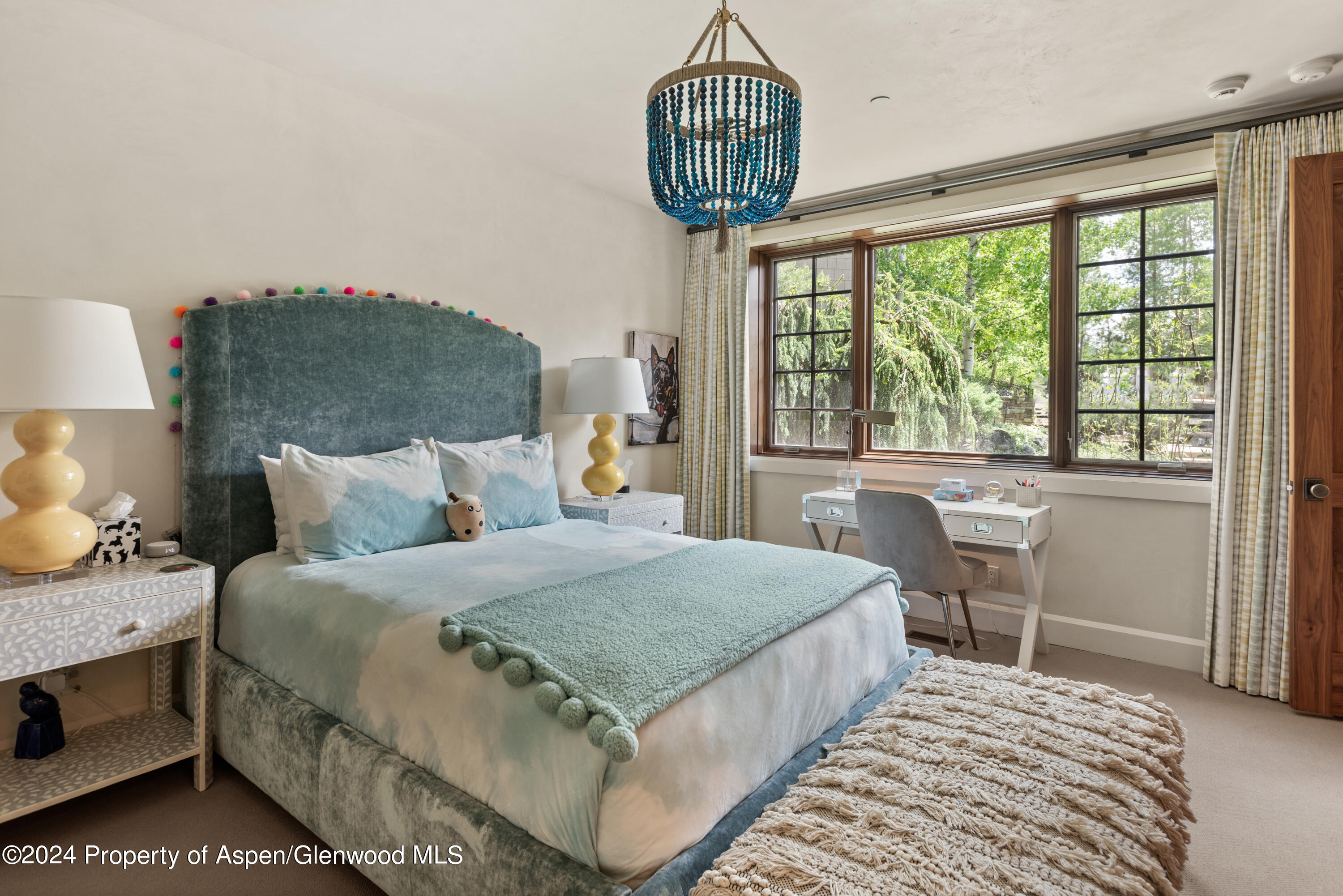 705 Spruce Street Aspen, CO 81611 - Photo 22 of 44 a bedroom with a bed chandelier and a window
