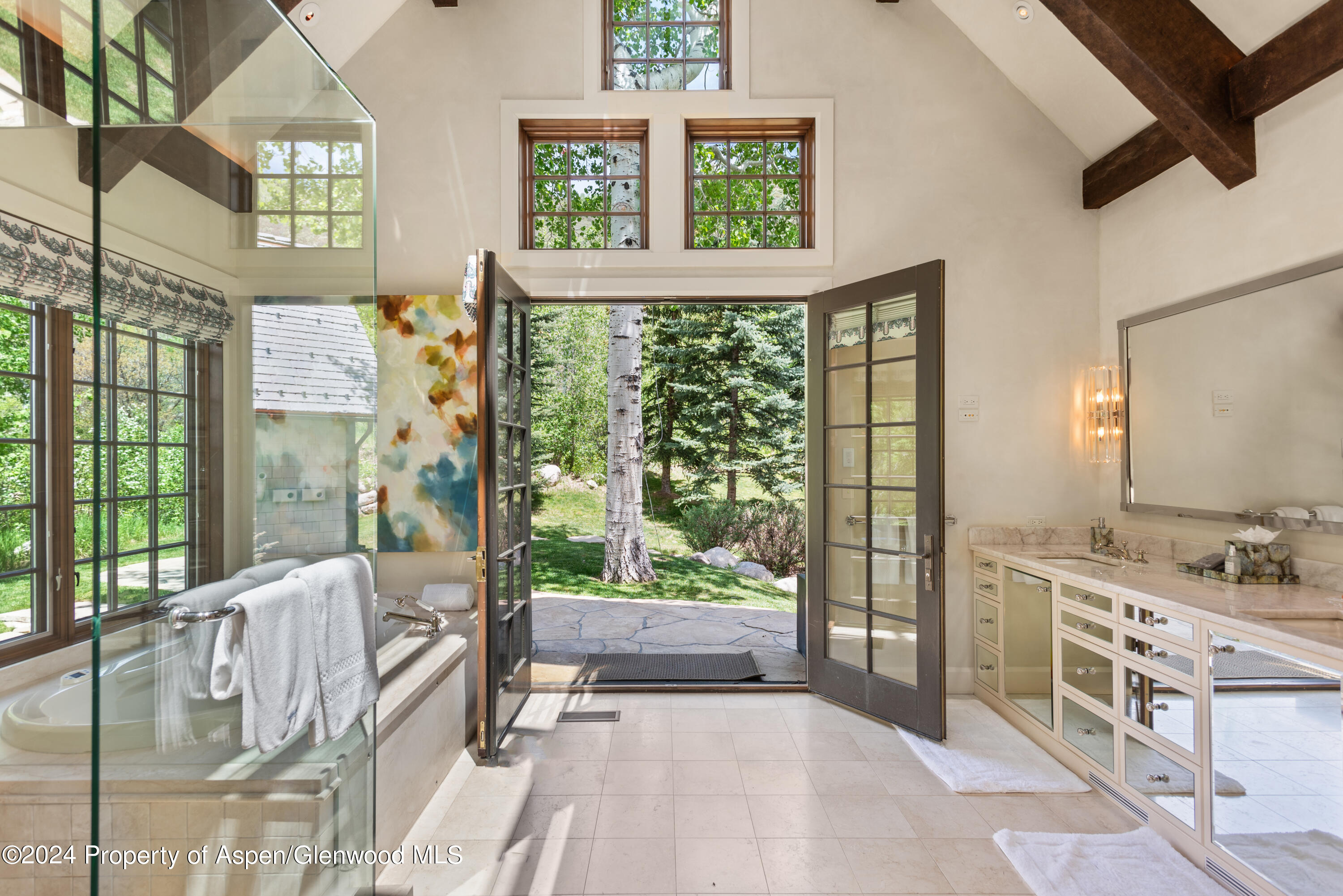 705 Spruce Street Aspen, CO 81611 - Photo 24 of 44 a spacious bedroom with a large bed and a window