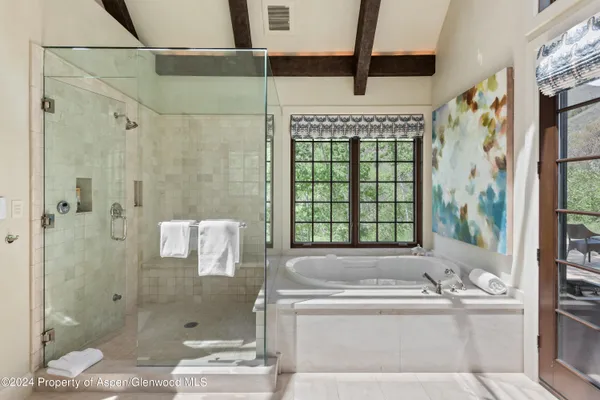 a bathroom with a bathtub and shower