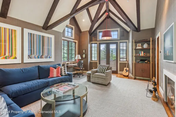 a living room with furniture and a floor to ceiling window
