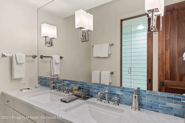 a bathroom with a double vanity sink and a mirror