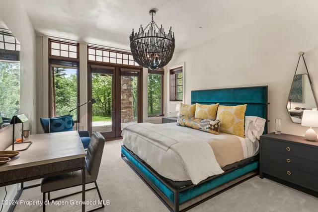 a large bed sitting in a bedroom next to a window