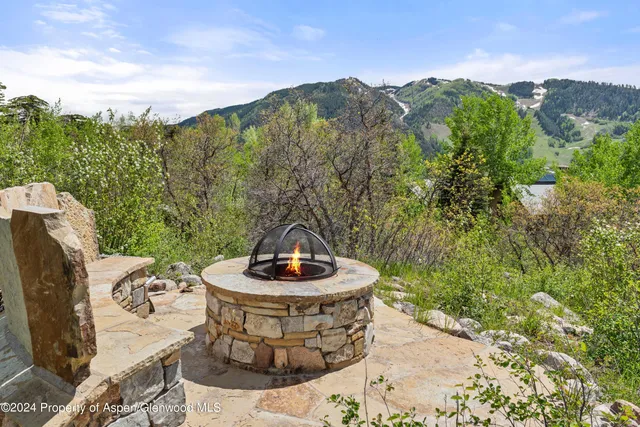 a view of a swimming pool with a yard and mountain view