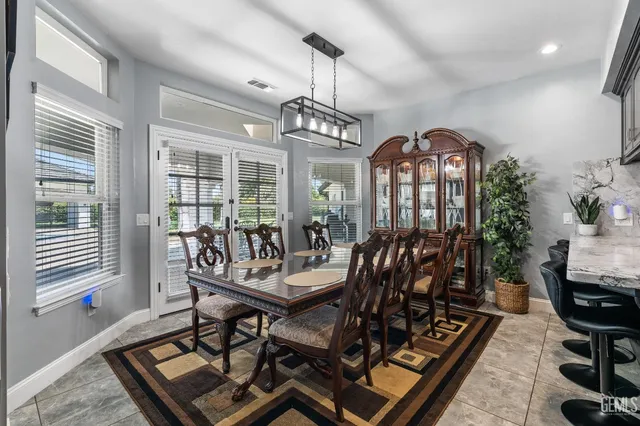 a kitchen with stainless steel appliances kitchen island granite countertop a refrigerator oven a sink dishwasher and a refrigerator