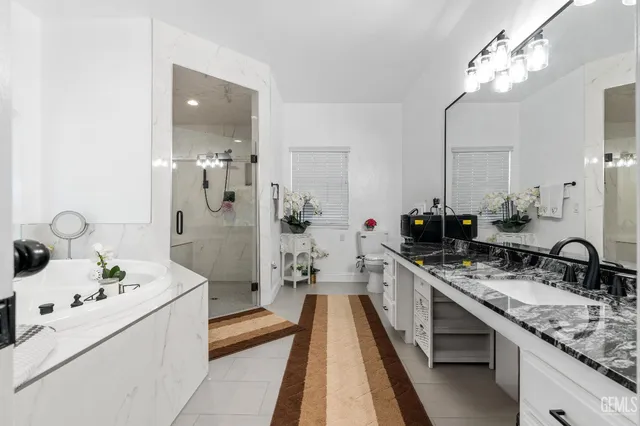 a bathroom with a granite countertop sink a mirror and vanity