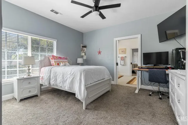 a view of a livingroom with workspace and a window