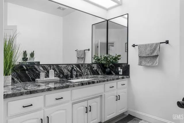 a bathroom with a shower and a sink