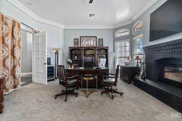a front view of a house with swimming pool table and chairs