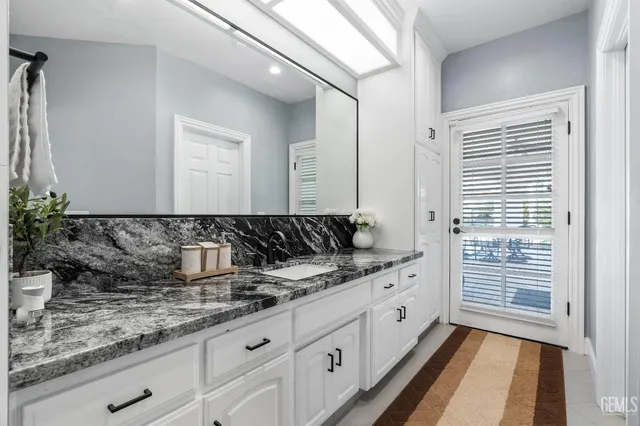 a view of a backyard with table and chairs and wooden fence