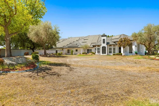 a view of a patio with table and chairs and potted plants