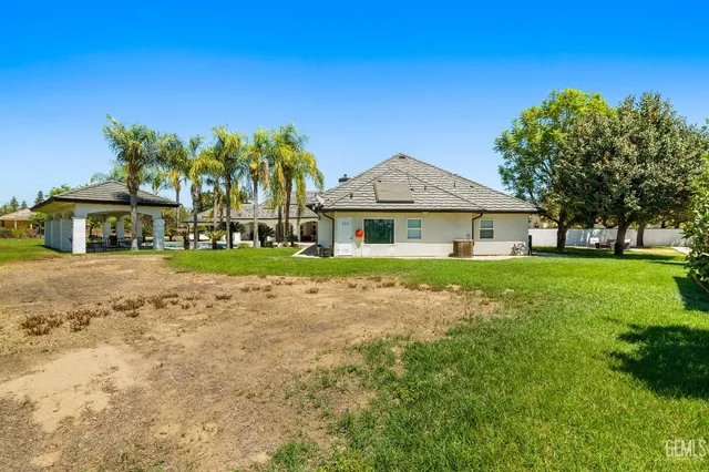 a living room with patio furniture and a floor to ceiling window