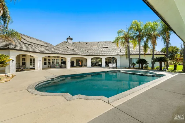 a swimming pool with outdoor seating and yard