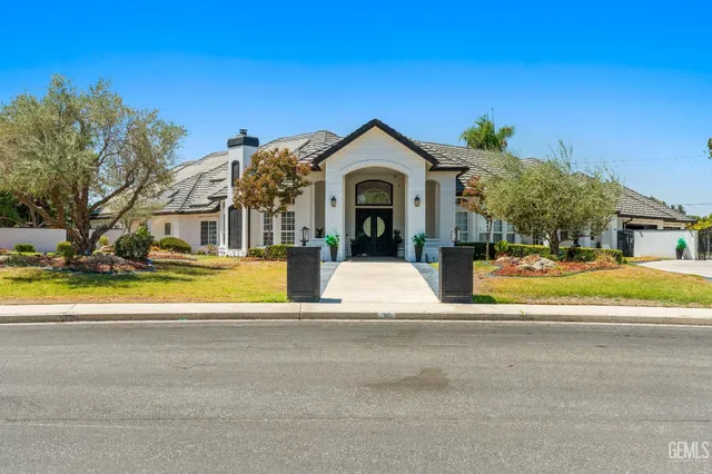 a living room with furniture a chandelier and a dining table