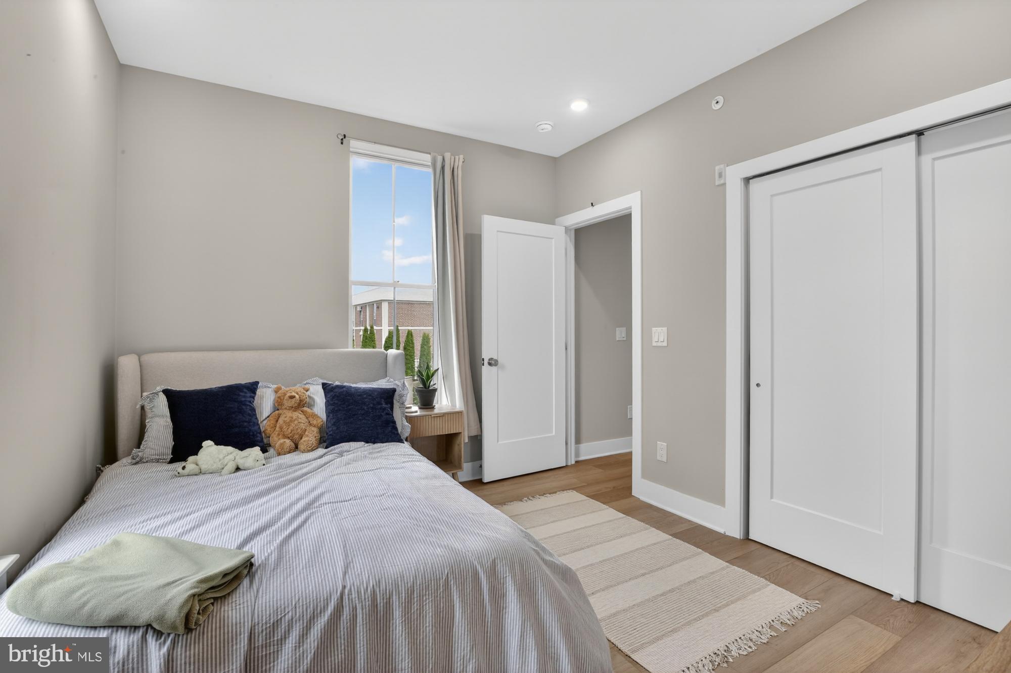 6712 Ridge Avenue, Unit 203 Philadelphia, PA 19128 - Photo 11 of 16 a bedroom with a bed and a window