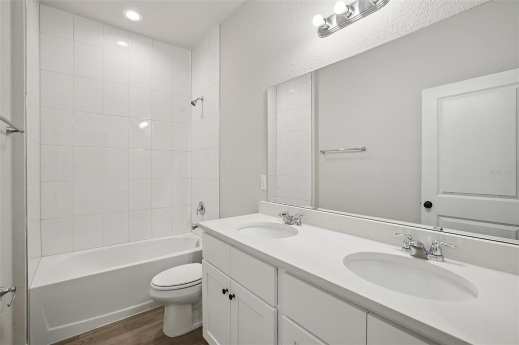 64 Cactus Street Homosassa, FL 34446 - Photo 11 of 12 a bathroom with a double vanity sink toilet mirror and bathtub