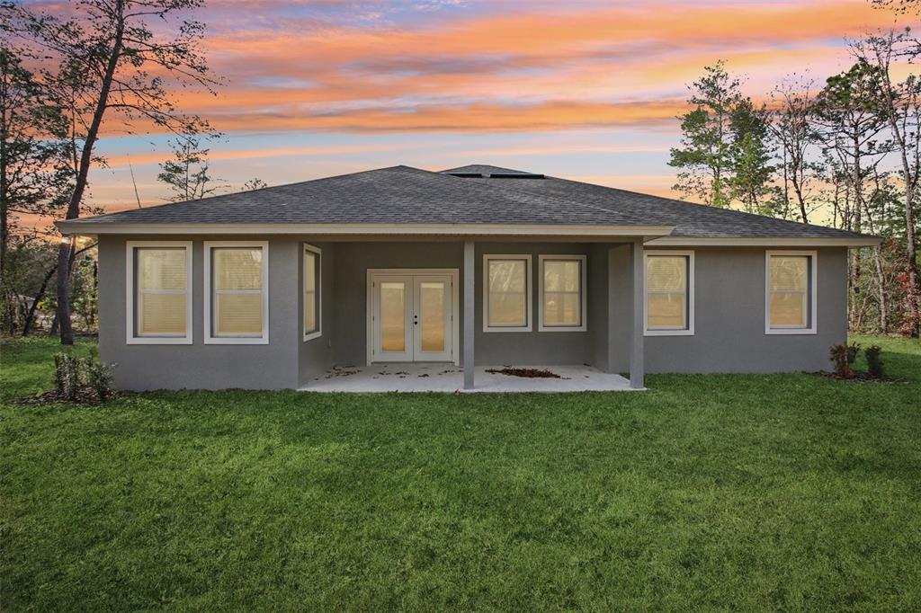 64 Cactus Street Homosassa, FL 34446 - Photo 12 of 12 a front view of a house with a yard