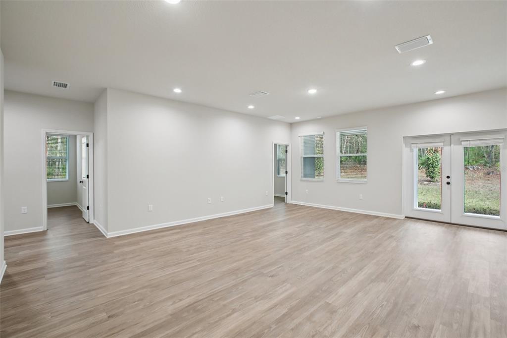 64 Cactus Street Homosassa, FL 34446 - Photo 3 of 12 a view of an empty room with wooden floor and a window