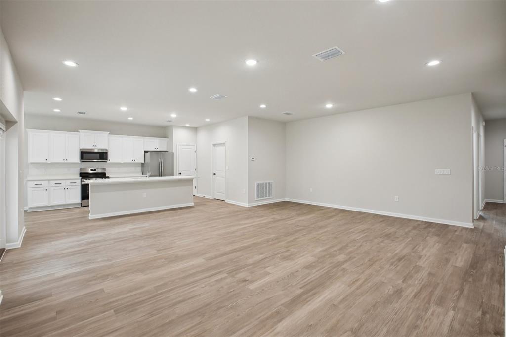 64 Cactus Street Homosassa, FL 34446 - Photo 5 of 12 a view of kitchen with white cabinets and stainless steel appliances