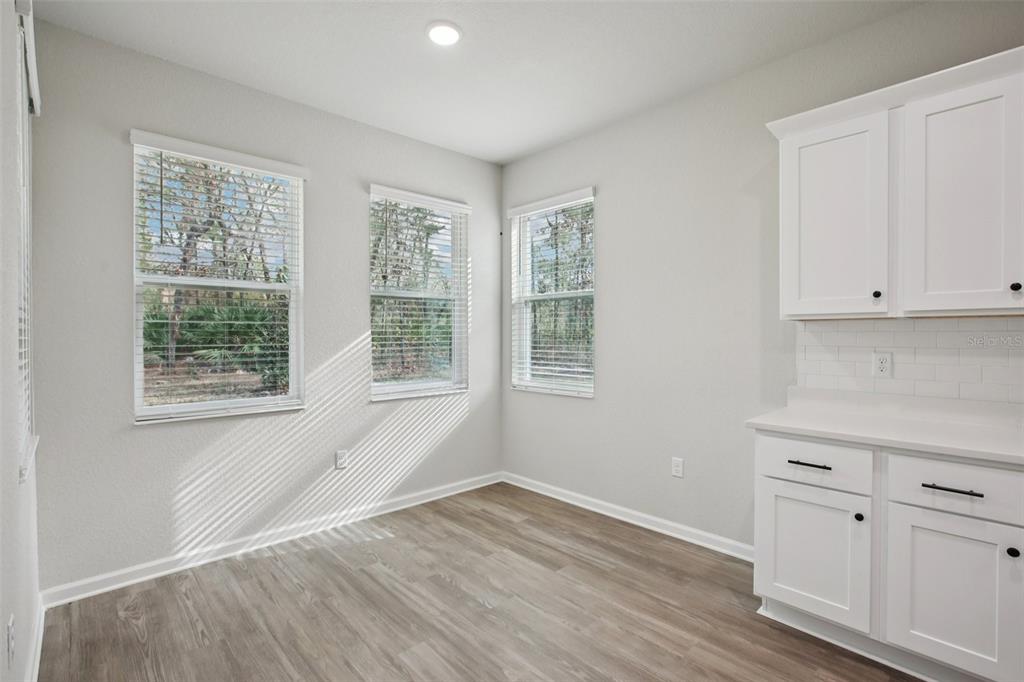 64 Cactus Street Homosassa, FL 34446 - Photo 8 of 12 wooden floor in an empty room with a window