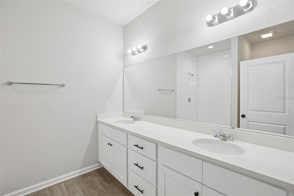 64 Cactus Street Homosassa, FL 34446 - Photo 10 of 12 a bathroom with a double vanity sink and a mirror