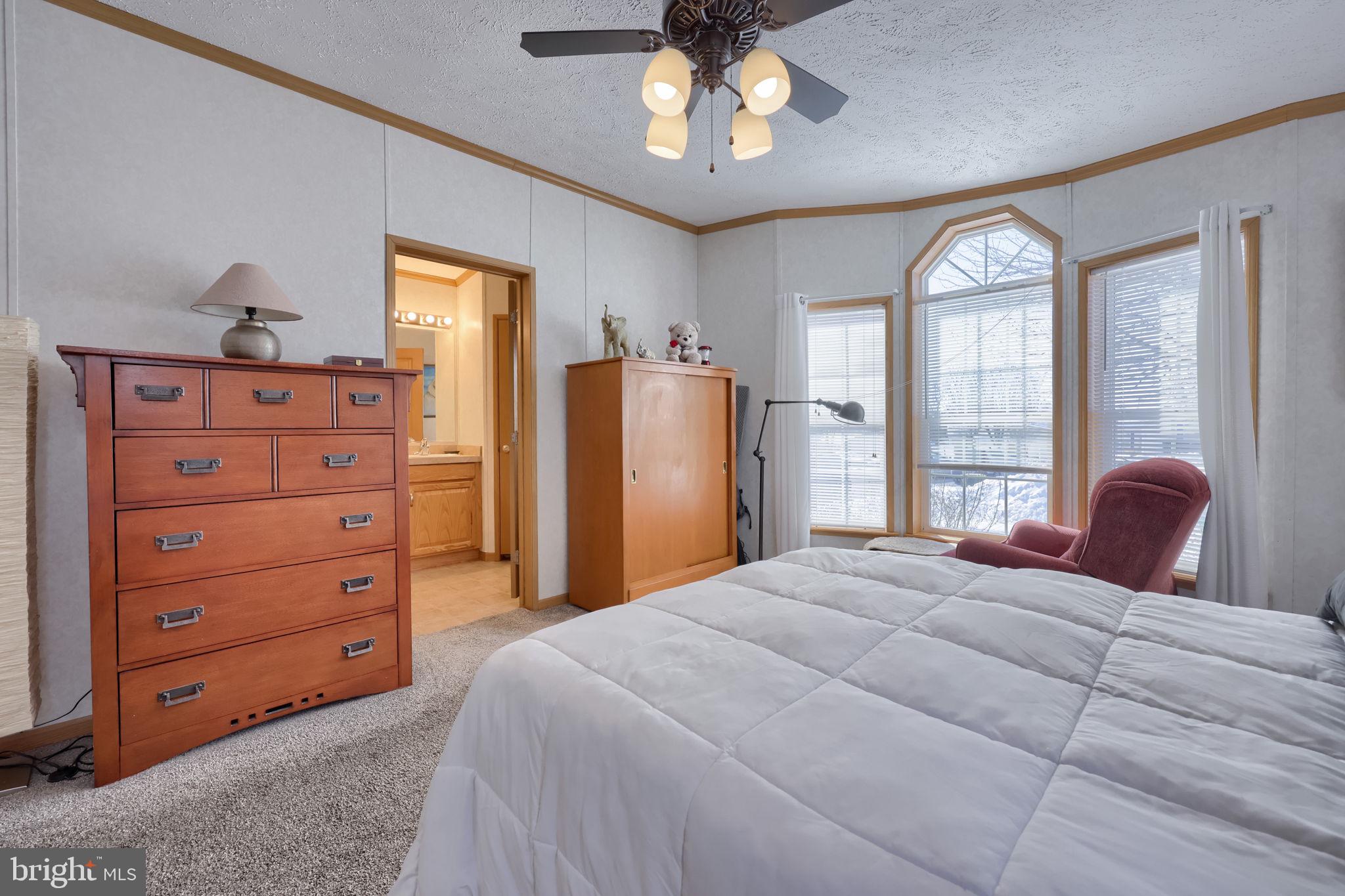 310 Summers Drive Lancaster, PA 17601 - Photo 19 of 44 a bedroom with a bed a chandelier and dresser