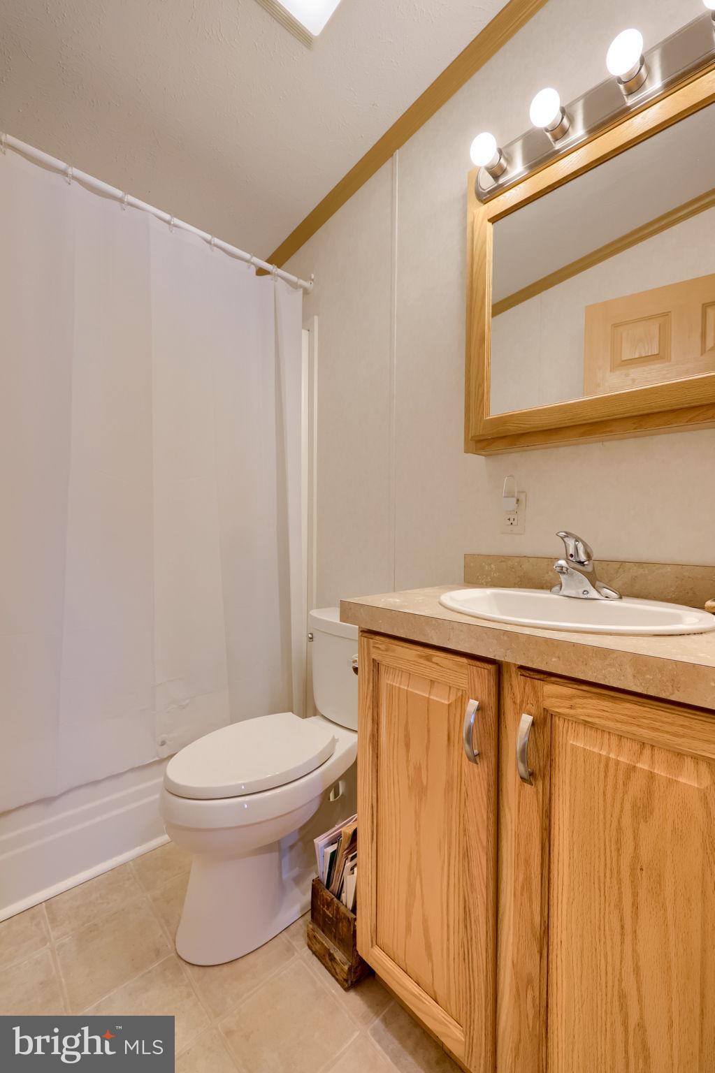 310 Summers Drive Lancaster, PA 17601 - Photo 24 of 44 a bathroom with a toilet a sink and a mirror