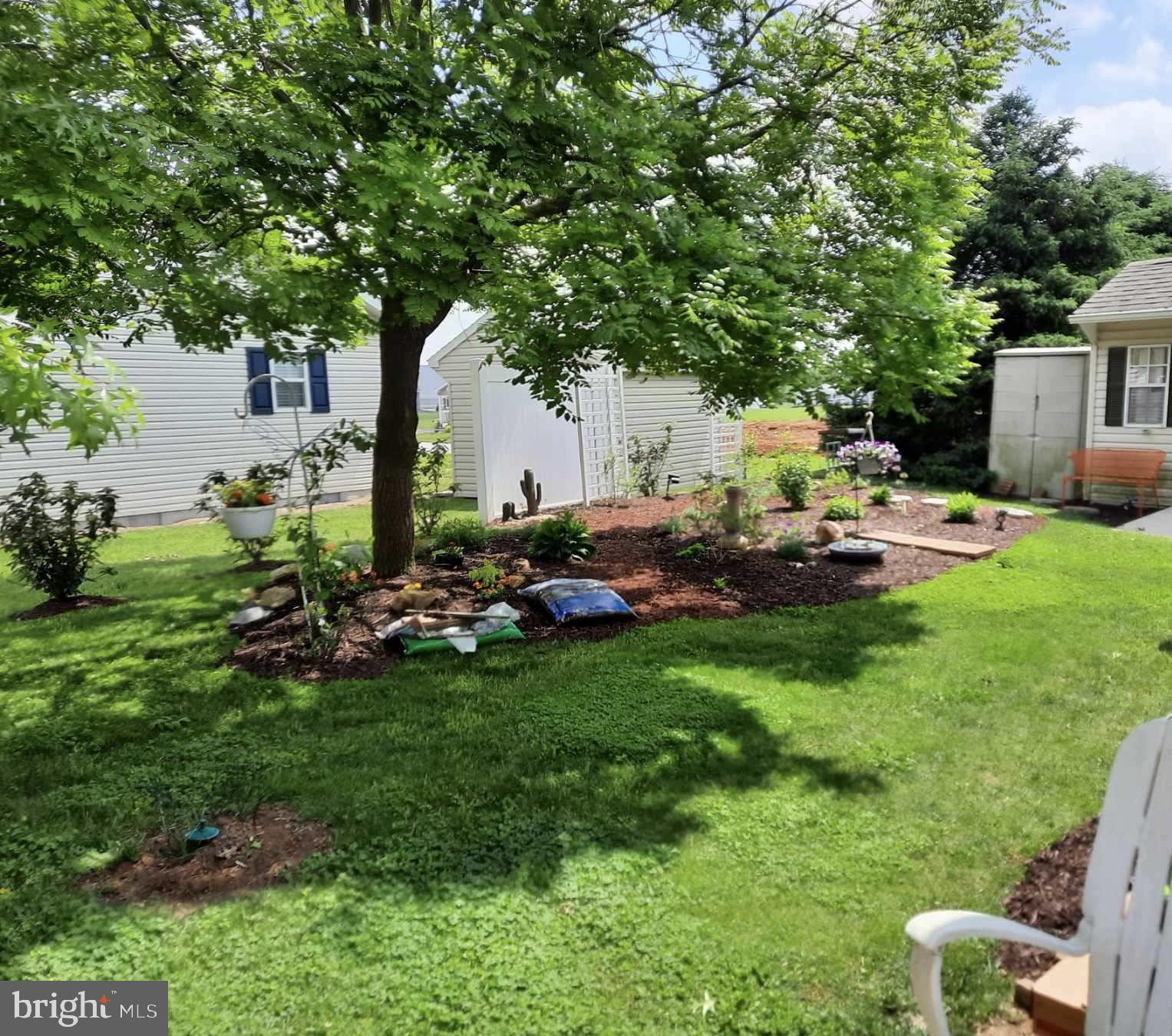 310 Summers Drive Lancaster, PA 17601 - Photo 39 of 44 a backyard of a house with table and chairs plants and large tree