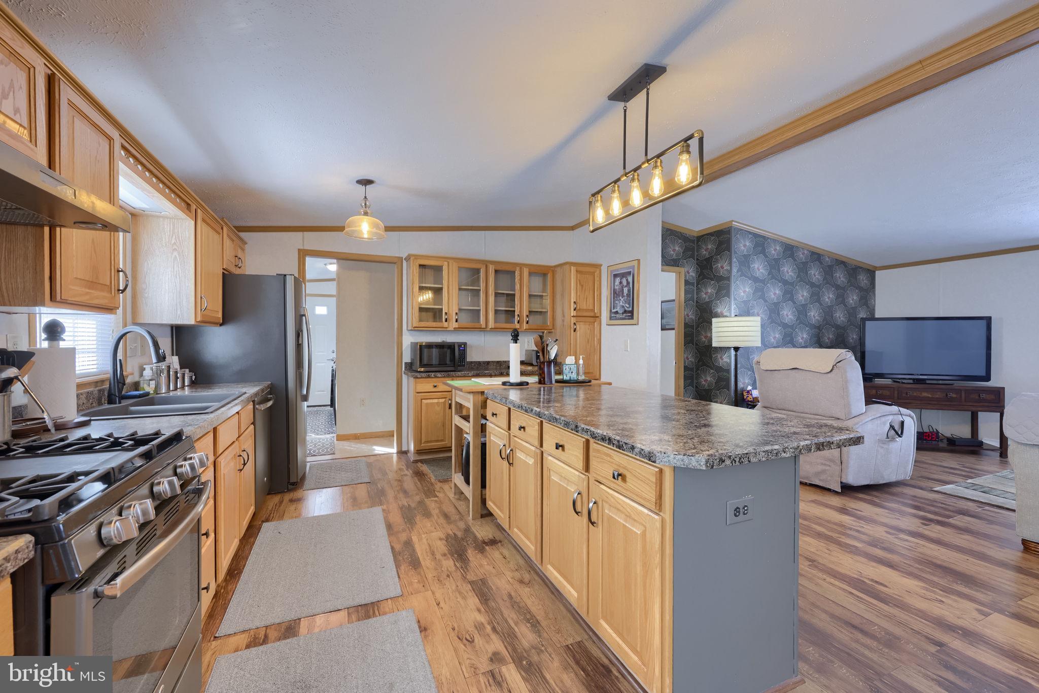 310 Summers Drive Lancaster, PA 17601 - Photo 9 of 44 a kitchen with stainless steel appliances granite countertop lots of counter top space and wooden floor